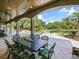 Inviting outdoor patio with a dining area, overlooking the sparkling pool and picturesque lake views at 116 Cherry Creek Cir, Winter Springs, FL 32708