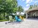 Relax on the patio with colorful Adirondack chairs near the outdoor kitchen at 116 Cherry Creek Cir, Winter Springs, FL 32708