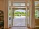 Scenic patio view showcasing a luxurious pool and serene backyard, framed by elegant curtains at 116 Cherry Creek Cir, Winter Springs, FL 32708