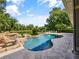This beautiful lagoon-style pool includes a rock waterfall and spa at 116 Cherry Creek Cir, Winter Springs, FL 32708