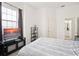 Bright bedroom with a queen-sized bed, black furniture, and a view of a window showing a sunset at 12016 Villanova Dr # 101, Orlando, FL 32837