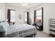 Spacious bedroom with a large window, a bed, TV, and shelf space at 12016 Villanova Dr # 101, Orlando, FL 32837