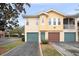 Charming townhome with a well-maintained lawn, attached garage and colorful door at 12016 Villanova Dr # 101, Orlando, FL 32837