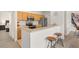 Functional kitchen with wooden cabinets, stainless steel appliances, and a breakfast bar at 12016 Villanova Dr # 101, Orlando, FL 32837