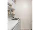 Clean laundry room with white washer and dryer and storage shelves at 12016 Villanova Dr # 101, Orlando, FL 32837