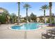 Community pool with palm trees and lounge chairs, creating a resort-style living environment at 12016 Villanova Dr # 101, Orlando, FL 32837