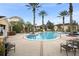 Community pool with palm trees and lounge chairs, creating a resort-style living environment at 12016 Villanova Dr # 101, Orlando, FL 32837