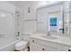 Bright bathroom featuring a shower-tub combination, toilet, and vanity with a large mirror at 1236 Villa Ln # 143, Apopka, FL 32712