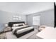 Cozy bedroom features a queen bed, nightstands with lamps, and a bright window at 1236 Villa Ln # 143, Apopka, FL 32712