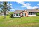 Charming home with a well-maintained lawn, a sunroom, and a neutral color scheme at 1236 Villa Ln # 143, Apopka, FL 32712