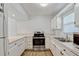 Spacious kitchen features white cabinets, stainless steel appliances, and light countertops at 1236 Villa Ln # 143, Apopka, FL 32712