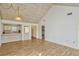 Open-concept living room with wood paneled ceiling, hardwood floors, and pass-through to the kitchen at 1236 Villa Ln # 143, Apopka, FL 32712