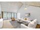 Bright living room featuring a vaulted ceiling, sliding glass doors, and stylish contemporary furnishings at 1236 Villa Ln # 143, Apopka, FL 32712