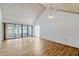 Bright living room featuring a vaulted ceiling, hardwood floors, and sliding glass doors to the sunroom at 1236 Villa Ln # 143, Apopka, FL 32712