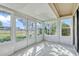 Light-filled sunroom with multiple windows offering views of the surrounding landscape at 1236 Villa Ln # 143, Apopka, FL 32712