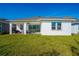 The backyard includes a covered patio with outdoor furniture and a barbecue, providing ample space for entertaining at 13301 Mcmillan Dr, Orlando, FL 32827