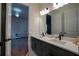 Shared bathroom with double sinks, quartz countertop, undermount sinks, and black hardware and trim at 13301 Mcmillan Dr, Orlando, FL 32827