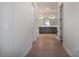 Hallway view of a modern bathroom featuring a double vanity with gray cabinets and ample lighting at 13301 Mcmillan Dr, Orlando, FL 32827