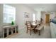 Bright dining room featuring a wooden table set, two large windows, and neutral wall color at 13301 Mcmillan Dr, Orlando, FL 32827