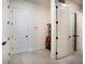 A clean and bright entryway with multiple doors, white trim, and light tile flooring at 13301 Mcmillan Dr, Orlando, FL 32827