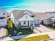 A spacious home featuring a two-car garage, covered porch, and inviting brick walkway, surrounded by well-kept landscaping at 13301 Mcmillan Dr, Orlando, FL 32827