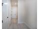 A bright hallway features fresh paint, crisp white trim, and luxury vinyl plank flooring at 13301 Mcmillan Dr, Orlando, FL 32827
