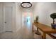 Bright hallway featuring tile floors, neutral walls, a modern light fixture, and stylish furnishings at 13301 Mcmillan Dr, Orlando, FL 32827