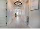 Long, bright hallway with recessed lighting, neutral walls and flooring, and decorative light fixtures at 13301 Mcmillan Dr, Orlando, FL 32827