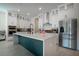 Modern kitchen with white cabinets, stainless steel appliances, a large island with a sink, and a stylish faucet at 13301 Mcmillan Dr, Orlando, FL 32827