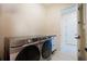 Laundry room featuring sleek front-loading washer and dryer set and neutral colored walls at 13301 Mcmillan Dr, Orlando, FL 32827