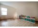 Bright room featuring wood floors, neutral walls, modern storage shelves, and a stylish geometric rug at 13301 Mcmillan Dr, Orlando, FL 32827