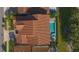 An aerial view of a house with a red tile roof and refreshing swimming pool and patio area, perfect for relaxation at 13307 Alderley Dr, Orlando, FL 32832