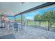 Covered balcony offers views of golf course, a dining table, and an exercise bike at 13307 Alderley Dr, Orlando, FL 32832