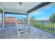 Inviting balcony area overlooking a scenic pond with comfortable seating, ideal for relaxing and enjoying outdoor views at 13307 Alderley Dr, Orlando, FL 32832