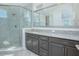 Modern bathroom with a glass-enclosed shower, granite countertops, and sleek cabinets at 13307 Alderley Dr, Orlando, FL 32832
