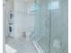 Stylish bathroom featuring glass-enclosed shower, toilet, stackable washer/dryer for ultimate convenience at 13307 Alderley Dr, Orlando, FL 32832