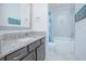 Modern bathroom with granite countertops, neutral cabinets, and a shower-tub combo, showcasing style and functionality at 13307 Alderley Dr, Orlando, FL 32832
