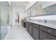 Bathroom showcasing dual vanities, granite countertops, and a large walk-in shower with glass surround at 13307 Alderley Dr, Orlando, FL 32832