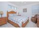 Cozy bedroom featuring a wooden bed frame and matching bedside tables, illuminated by natural light from the windows at 13307 Alderley Dr, Orlando, FL 32832