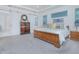 Bright bedroom featuring a sleigh bed, wood dresser, gray carpet, and natural light from a high transom window at 13307 Alderley Dr, Orlando, FL 32832