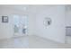 Well-lit bedroom with neutral walls, white wood flooring, ceiling fan, and French doors, offering a tranquil space at 13307 Alderley Dr, Orlando, FL 32832