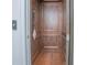 Private home elevator with wooden interior paneling and flooring for easy access between levels, providing convenience and accessibility at 13307 Alderley Dr, Orlando, FL 32832