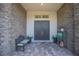 Charming front porch with stone accents, double doors, and cozy seating at 13307 Alderley Dr, Orlando, FL 32832