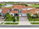 Stunning two-story home boasts a tile roof, stone accents, balcony, two-car garage, and beautiful landscaping at 13307 Alderley Dr, Orlando, FL 32832