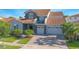 Beautiful home with a red tile roof, manicured lawn, and two-car garage at 13307 Alderley Dr, Orlando, FL 32832