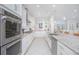 Modern kitchen with stainless steel appliances, white cabinetry, and beautiful granite countertops at 13307 Alderley Dr, Orlando, FL 32832