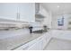 Close-up of kitchen showcasing stainless steel appliances, granite countertops, and white cabinetry at 13307 Alderley Dr, Orlando, FL 32832