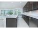 Open kitchen with dark cabinets, granite countertops, stainless steel appliances, and easy access to the living room at 13307 Alderley Dr, Orlando, FL 32832
