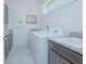 Functional laundry room with granite countertops, cabinets, sink, and modern appliances, offering convenience and ample workspace at 13307 Alderley Dr, Orlando, FL 32832