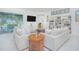 Bright living room with bookcase, comfortable seating, and views of the pool at 13307 Alderley Dr, Orlando, FL 32832